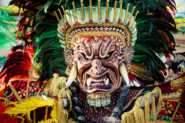 closeup man in colorful native indian mask poses for photo at dominican carnival - obrazy, fototapety, plakaty