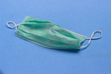 Photo, Light Green Surgical mask at white background for prevention from covid-19 and other virus...