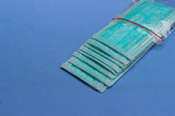 Photo, Light Green Surgical mask at white background for prevention from covid-19 and other virus...