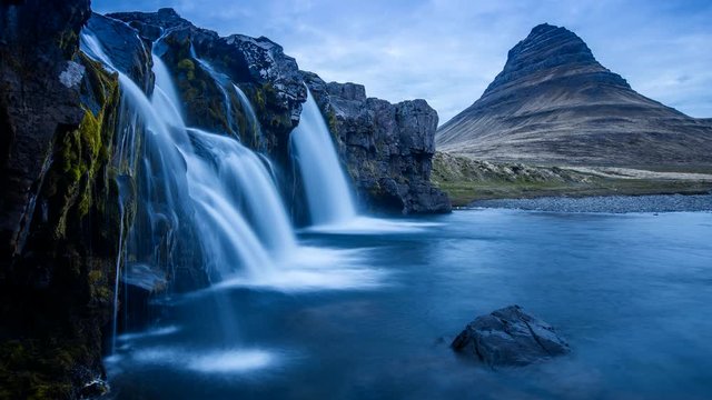 Iceland 4K timelapse photography of waterfall and famous mountain. Kirkjufellsfoss and Kirkjufell in northern Iceland nature landscape