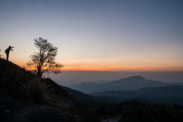 Fototapeta na wymiar Twilight and morning sun at a viewpoint in the mountains of northern Thailand on a new day
