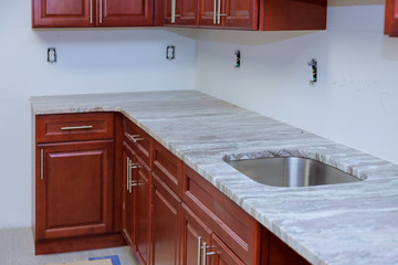 Installing new kitchen counter top new cabinet in a home