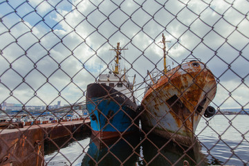 Old rusty ships stand at the pier in the Golden Horn Bay. Old ships at the factory awaiting repair.