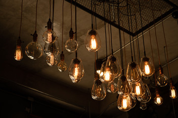 House interior of loft and rustic style. Beautiful vintage luxury light bulb hanging decor glowing...