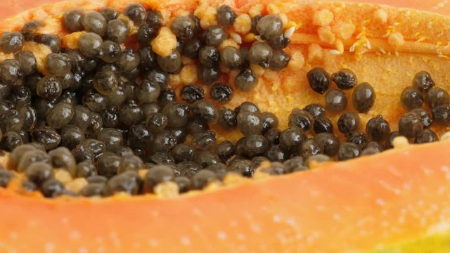 Top view of ripe half cut papaya. Rotate. Food background
