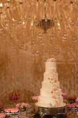Fototapeta na wymiar Wedding Setup. Cake table with sweet, decoration and flowers 