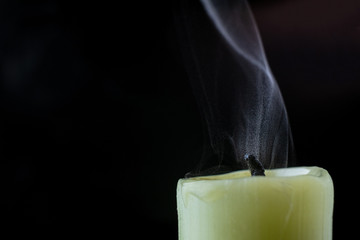 the smoke of an extinguished candle on a black background close up