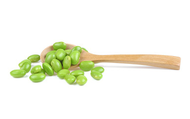 edamame green beans in wooden spoon isolated on white background