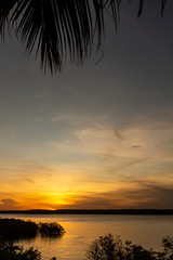 Fototapeta na wymiar Beautiful sunset in the lagoon. The golden colors bathe the sky. Coastal landscape.