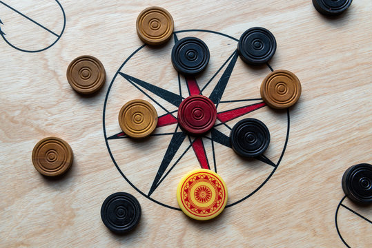 Carom board with striker and carom men. Selective focus.