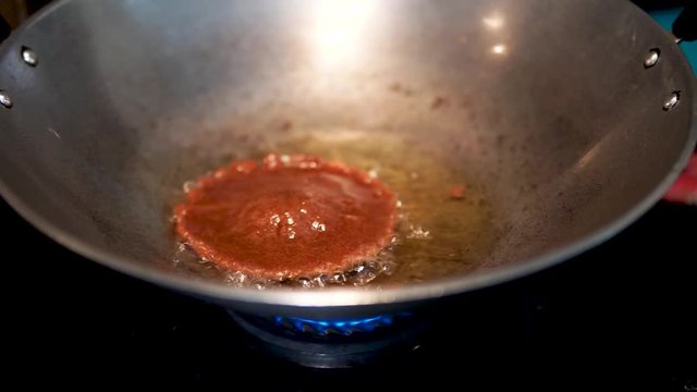 Process of making a homemade Cucur Jawa or Cucur Topi in a hot boiling oil.