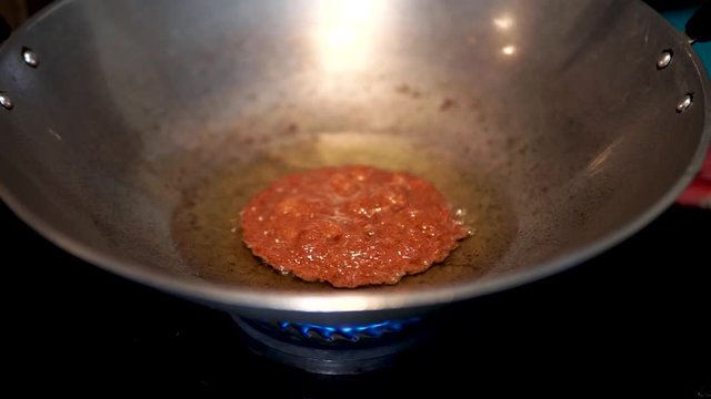 Process of making a homemade Cucur Jawa or Cucur Topi in a hot boiling oil.