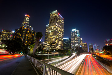 Long exposure photo of cars racing along the 110 Freeway through Downtown Los Angeles, California during evening rush hour.