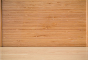 Empty wood table with bamboo background. Bamboo products that have been processed into trays for use in the kitchen. Top view of plank wood for graphic stand design product. © pattanawit