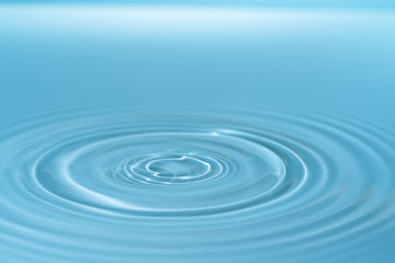 Waves on the surface of the water from a collision. Drop of water drop to the surface.