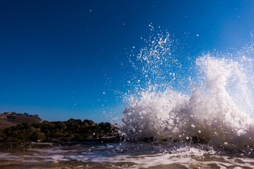 A surge of surf waves on a rocky shore