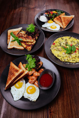 Breakfast food table. Festive brunch set, meal variety with fried egg, pancakes, croissants, smoothie ,fresh berries and fruits. Overhead view