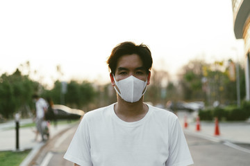 Portrait of a asian male worried corona virus with black hair wearing medical face maskand showing hand sign