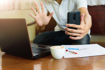 Work from home /The man use video conference by smartphone in working time from home