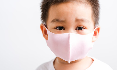 little child boy wearing cloth face mask protective