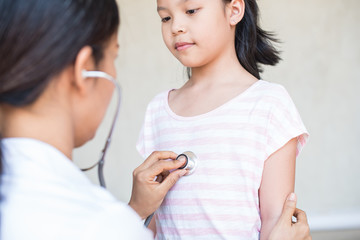 professional general medical pediatrician doctor gown listen lung and heart sound of asia child patient with stethoscope. for virus symptom. epidemic coronavirus (2019-nCoV) outbreak concept.