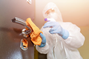 Disinfection and cleaning door handles of house from infection with virus and microbes in...