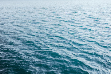 blue emerald water surface with small waves