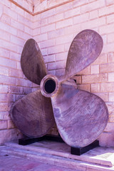 Huge boat propeller in front of the facade
