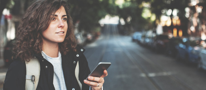 Handsome Brunette Woman With Mobile Phone Walking On The Street