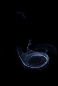 The movement of smoke on a black background, abstract smoke background on a black background