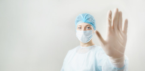 Woman in respirator showing stop gesture. stop viruses concept.