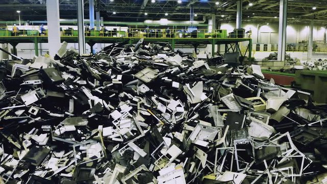 Waste, plastic trash, garbage recycling plant. A pile of broken consumer electronics in a junkyard unit