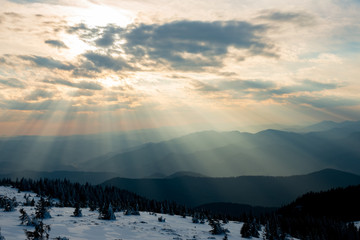 sunbeams among the clouds on the snowy mountain