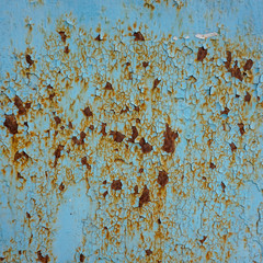   Old rusty iron, once painted with blue paint, and now peeling.
