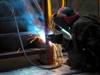 Welding work ,worker with protective welding metal on construction