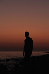 Silhouette of a man at sunset on the beach