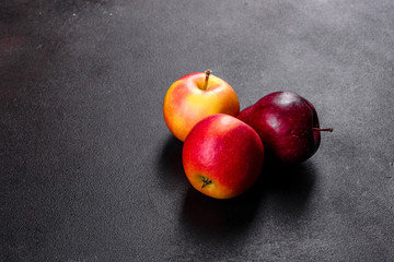 Fresh juicy red apple with droplets of water against dark background