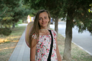 A girl walks around the city in the summer