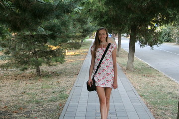 A girl walks around the city in the summer