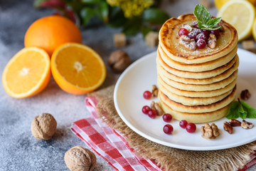 Delicious fresh beautiful pancakes with citrus honey and jam