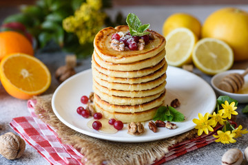 Delicious fresh beautiful pancakes with citrus honey and jam