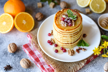 Delicious fresh beautiful pancakes with citrus honey and jam