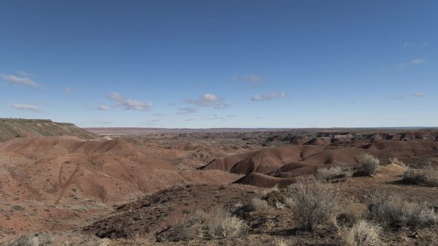 An ultrawide timelapse shot of the Painted Desert near Petrified Forest, as clouds rush past.
