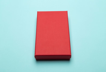 Red box product packaging isolated on blue background.