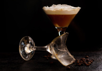 alcohol coctail glass on a black background. next to it is a broken, dirty glass. horizontal banner for designers