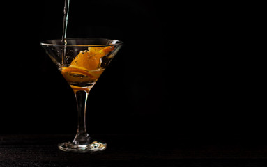 alcohol coctail on black background. cocktail with oranges. alcohol coctails are poured. horizontal banner for designers