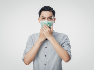 Young Asian Businessman wearing hygienic mask to prevent infection, 2019-nCoV or coronavirus. Airborne respiratory illness such as pm 2.5 fighting and flu isolated on white background.