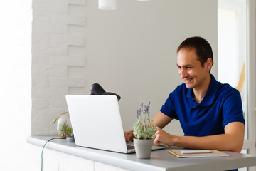 Man having video chat with doctor on laptop at home