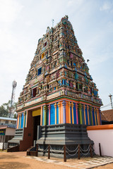 Traditional Hindu temple Kidangamparambu Sree Bhuvaneswari in India in Allapuzha (Allepi) Kerala. A tall building with colorful figures of Indian mythology and a flock of live birds.