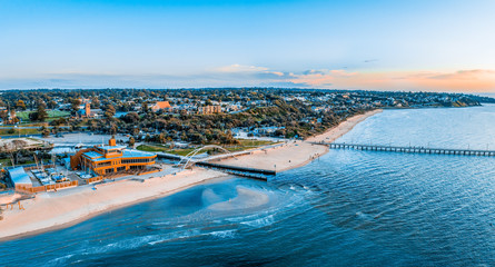 Fototapeta premium Aerial panorama of Frankston Yacht Club, footbridge and the pier at sunset in Melbourne, Australia